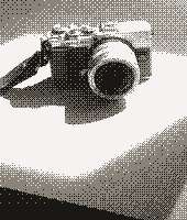 Pixel art of an Olympus Pen camera on a sunlit table