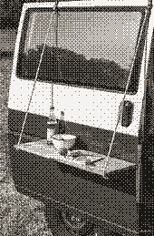 Pixel art of a campervan with a fold-out hanging table set with a bowl and bottle